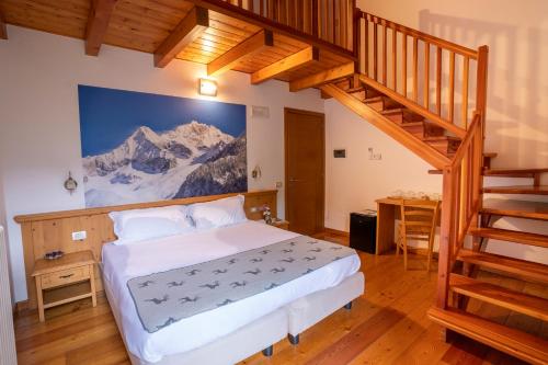 a bedroom with a large bed and a staircase at Il Bisteca in Morbegno