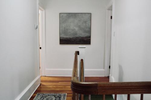 a hallway with a chair and a painting on the wall at Cozy Ski House Retreat minutes to Belleayre Mountain Resort in Fleischmanns