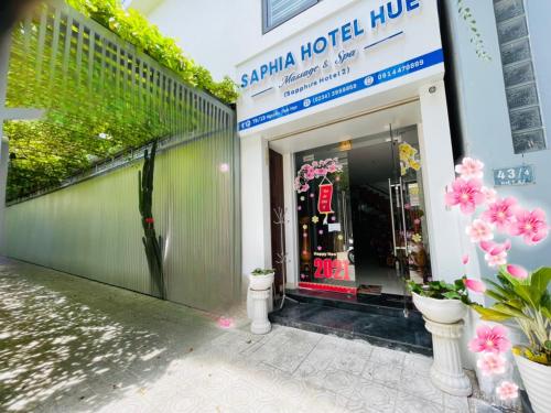 a store front with pink flowers outside of it at Saphia Hotel Huế (sapphire Hotel 2) in Hue