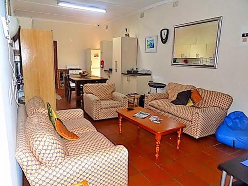 a living room with couches and a table at Shark shacks in Mossel Bay