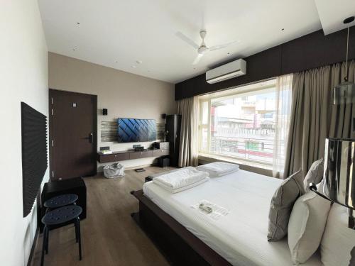 a hotel room with a bed and a window at Central Bed & Breakfast in Kolkata