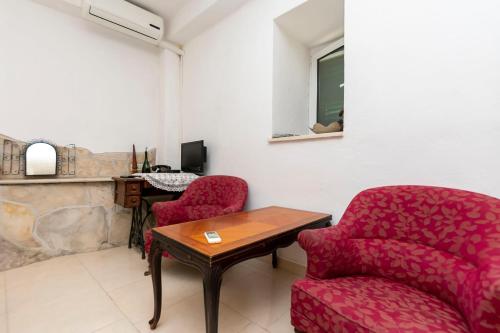 a living room with two chairs and a table at House Stipan in Vinišće