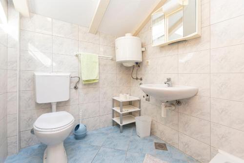 a bathroom with a toilet and a sink at House Ante in Vinišće