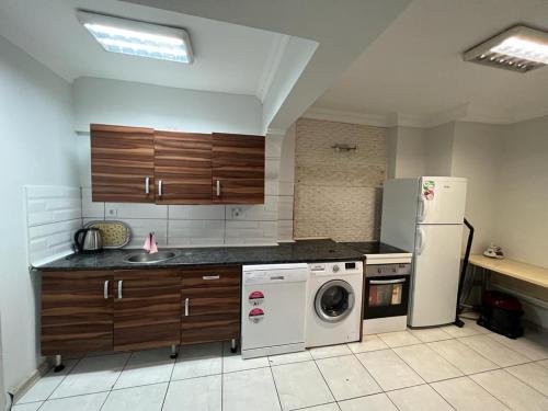 a kitchen with a refrigerator and a washing machine at Taksim Beyoğlu Talimhane apart in Istanbul