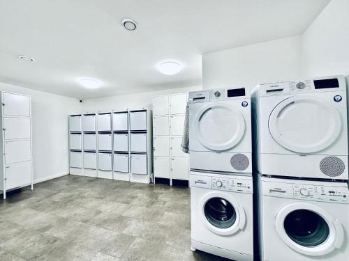 a laundry room with two washer and dryer at Monteurzimmer - Worker's accommodation - ZIMMERzuVERMIETEN in Deitingen Industriestrasse in Deitingen