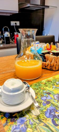 a glass jug of orange juice sitting on a table at Da Mary in Badia Prataglia