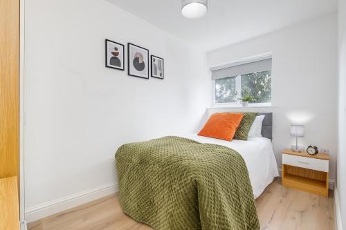 a white bedroom with a bed and a window at Alpha House by Night Stay: Contractors Sleeps 8 in Birmingham