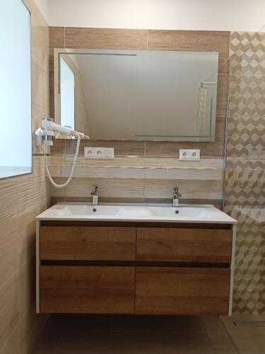 a bathroom with a sink and a large mirror at Chalupa u Mikeše in Žďár nad Sázavou