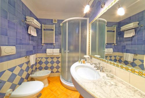 a bathroom with a sink and a toilet at Hotel Mare Blu Terme in Ischia