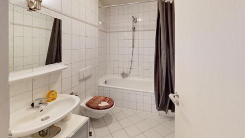 a bathroom with a sink and a toilet and a bath tub at zentrales Loft mitten in Leipzig in Leipzig