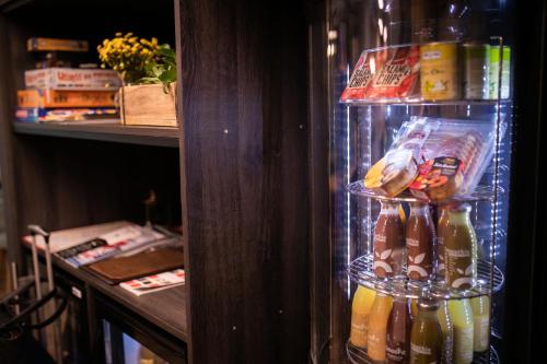a refrigerator filled with drinks and food at Hotel Vesper House in Gdańsk