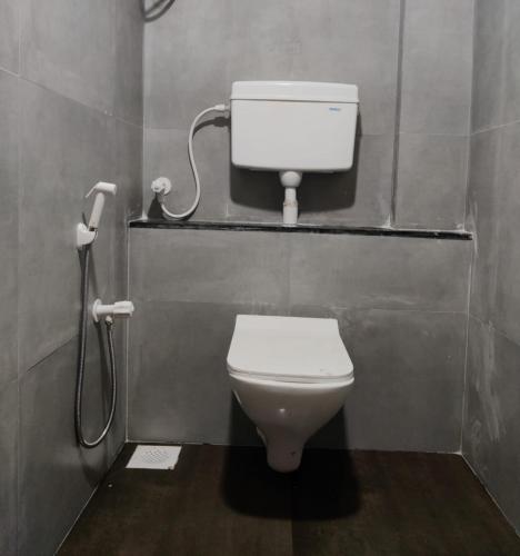 a bathroom with a toilet in a stall at Hilltop Resort and Glamping Wai, Near Panchgani in Wai