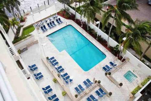 an overhead view of a swimming pool with blue lounge chairs at Avi Lux Stay in Fort Lauderdale