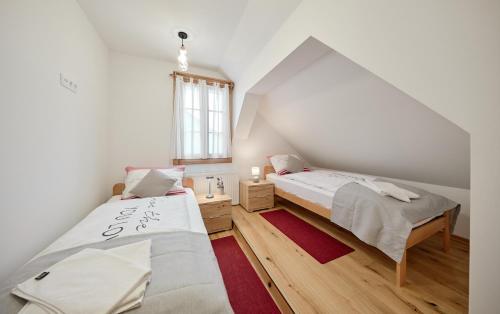 two beds in a room with a attic at Vila IVAN in Velika Gorica