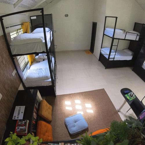 an overhead view of a dorm room with bunk beds at beNomadic Eco Hostel, Madikeri, Coorg in Suntikoppa