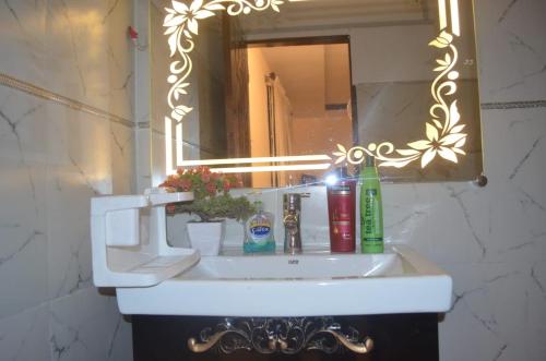 a white sink in a bathroom with a mirror at Charming Home banglow in Karachi