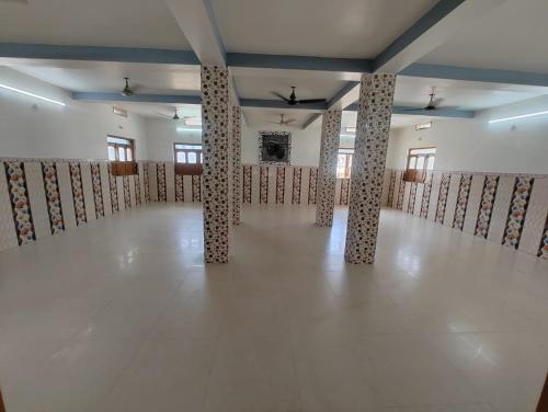 a large room with columns in the middle of it at VIP Guest House Bodhgaya in Gaya