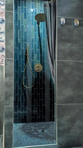 a shower with a glass door in a bathroom at LA GALANTE in Faugères