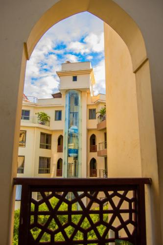 a view of a building through an archway at ZaNaKri Homes ;A Great Panorama of Indian Ocean in Mombasa