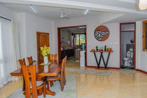 a dining room and kitchen with a table and chairs at ZaNaKri Homes ;A Great Panorama of Indian Ocean in Mombasa