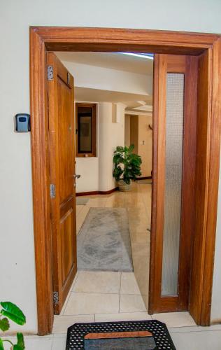 an open door to a hallway with a tile floor at ZaNaKri Homes ;A Great Panorama of Indian Ocean in Mombasa