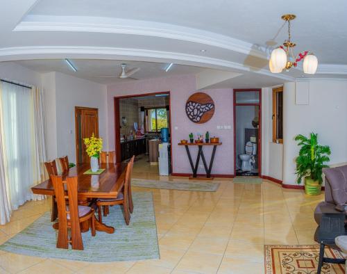 a dining room and living room with a table and chairs at ZaNaKri Homes ;A Great Panorama of Indian Ocean in Mombasa