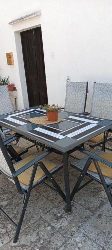 a picnic table with chairs and a plant on it at Nona Ružica in Vis