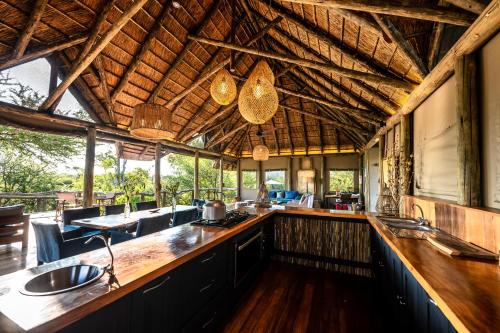 una cocina al aire libre con barra y bar en South Okavango - Omogolo Hideaways, en Rammu