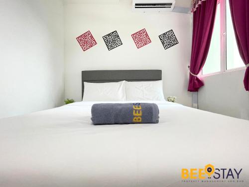a bedroom with a bed with a pillow on it at KLIA Ehsan Residences Sepang Nilai in Sepang