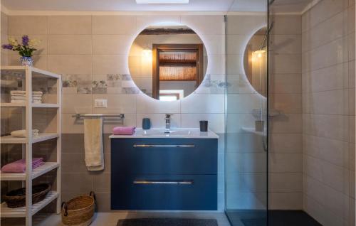 a bathroom with a blue sink and a mirror at Cozy Home In Civitaquana With Private Swimming Pool, Can Be Inside Or Outside in Civitaquana