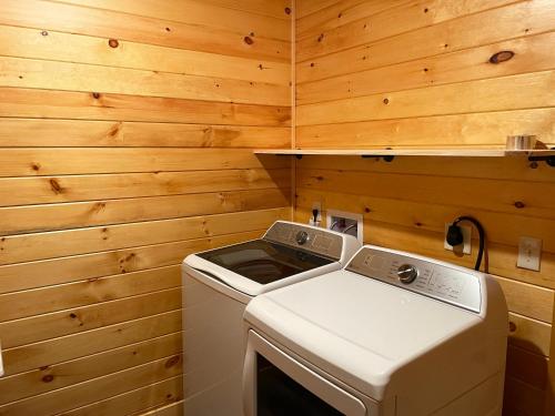 a washer and dryer in a room with wooden walls at Alpine Valley in McHenry