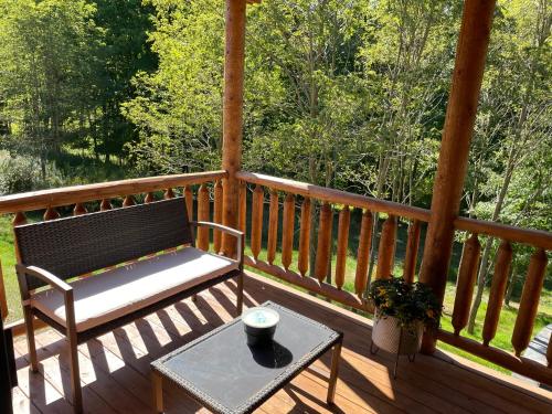 a bench sitting on a porch with a table at Alpine Valley in McHenry
