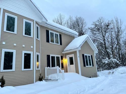 a house with snow on the side of it at New luxury spacious 3BR 3BA 1 mile from Mt Snow in Dover