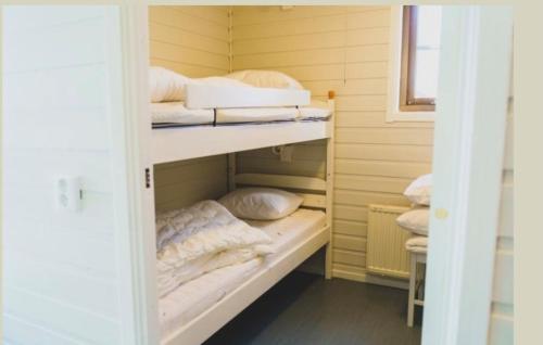 a room with two bunk beds with towels and pillows at Mösseberg Camping in Falköping