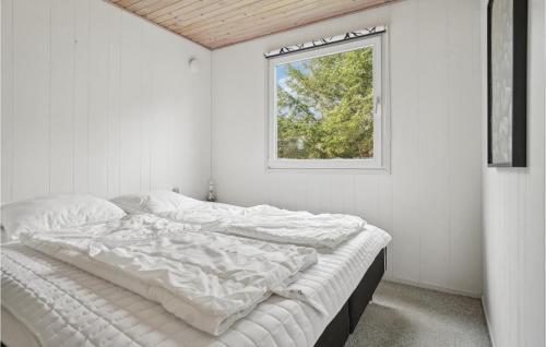 a white bedroom with a bed with a window at Awesome Home In Thisted With Kitchen in Sønder Vorupør