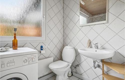 a bathroom with a washing machine and a sink at Awesome Home In Thisted With Kitchen in Sønder Vorupør