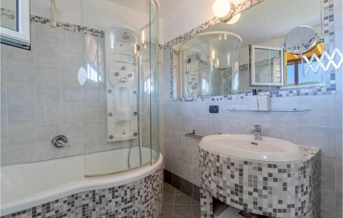 a white bathroom with a sink and a shower at Casa Relax In Collina in Castiglione Chiavarese
