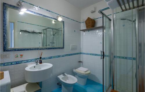 a bathroom with a sink and a toilet and a mirror at Stunning Apartment In Porto Santelpidio With Wifi in Porto SantʼElpidio
