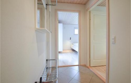 a view of a hallway with a white door at Beautiful Home In Frvang With 3 Bedrooms, Wifi And Outdoor Swimming Pool in Fårvang