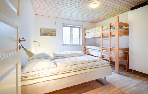 a bedroom with two bunk beds and a window at Beautiful Home In Frvang With 3 Bedrooms, Wifi And Outdoor Swimming Pool in Fårvang