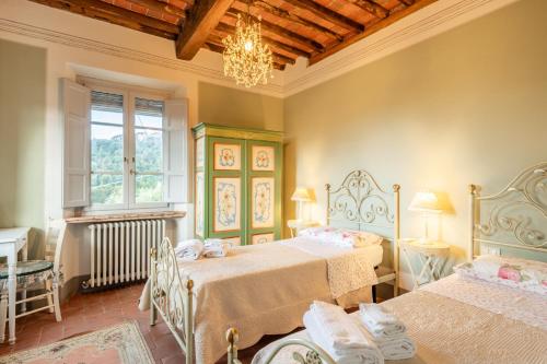 מיטה או מיטות בחדר ב-Villa Pardini