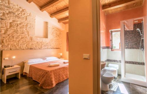 a bedroom with a bed and a bathroom at Tenuta Licitra in Ragusa