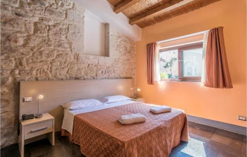 a bedroom with a bed with two towels on it at Tenuta Licitra in Ragusa