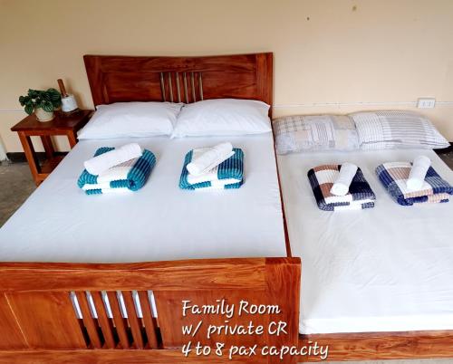 two beds with towels and pillows on them at Batad Countryside in Banaue