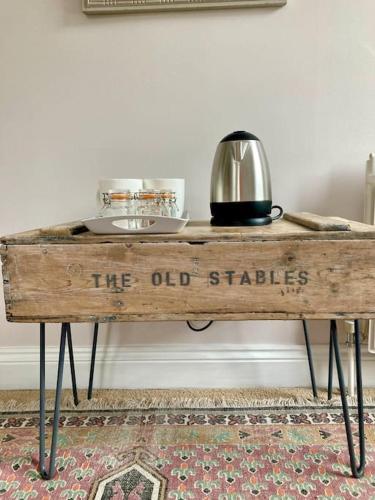 a wooden table with the old sticks written on it at The Old Stables, The River Severn, Shrewsbury in Shrewsbury