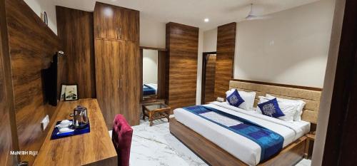 a hotel room with a bed and a table and a desk at HOTEL SILVER STONE in Ludhiana
