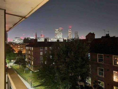 a view of a city skyline at night at Charming studio in Bricklane in London