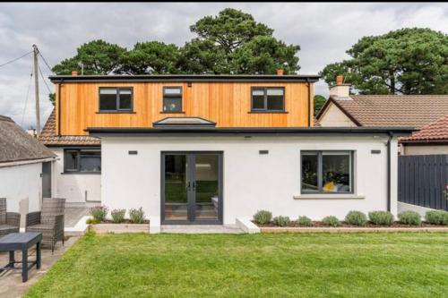 a house with a wooden roof on top of a yard at Pine View Holiday Home in Newcastle