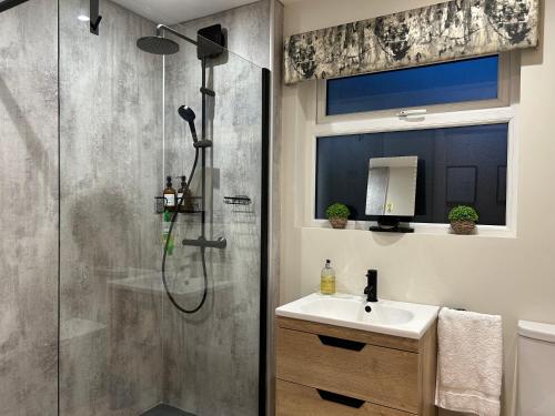 a bathroom with a shower and a sink at Pine View Holiday Home in Newcastle