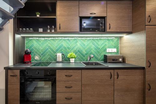 a kitchen with a sink and a microwave at Dessewffy Premium Apartment in Budapest